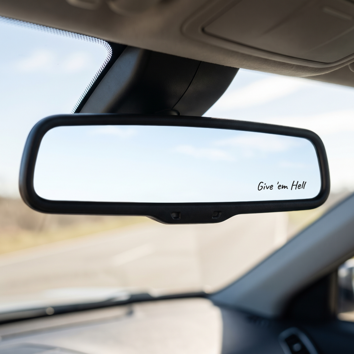 Give 'em Hell — Stickatude white-script rearview mirror decal on the mirror glass